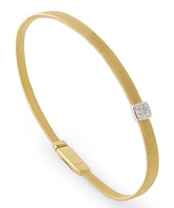 A gold bracelet with a diamond accent was crafted by world-renowned designer Marco Bicego